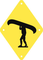black silhouette of Person Portaging Canoe on bright yellow diamond-shaped background with holes in four corners, approx 17cm/6.65